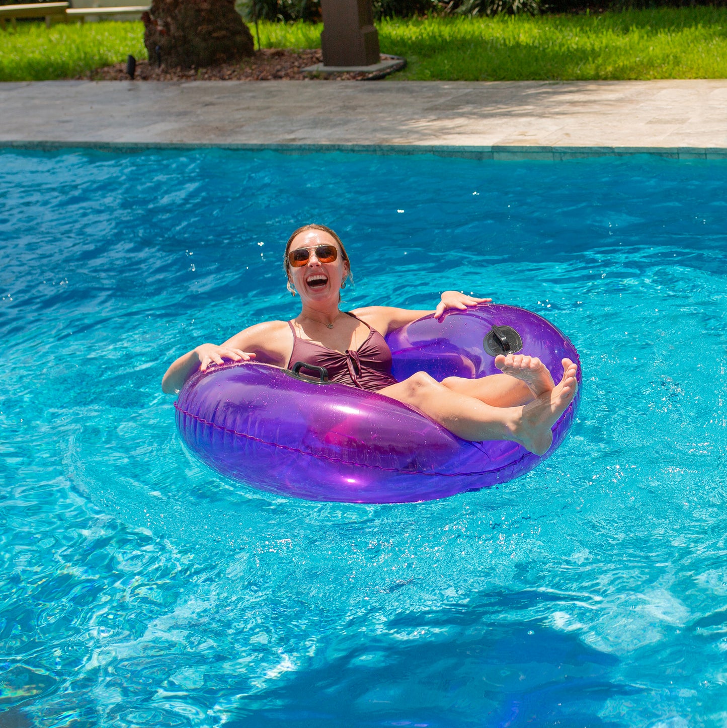 PoolCandy Translucent Purple Inflatable Swim Ring by PoolCandy with pro handles in 48" size. Pro level pool, beach and river float.