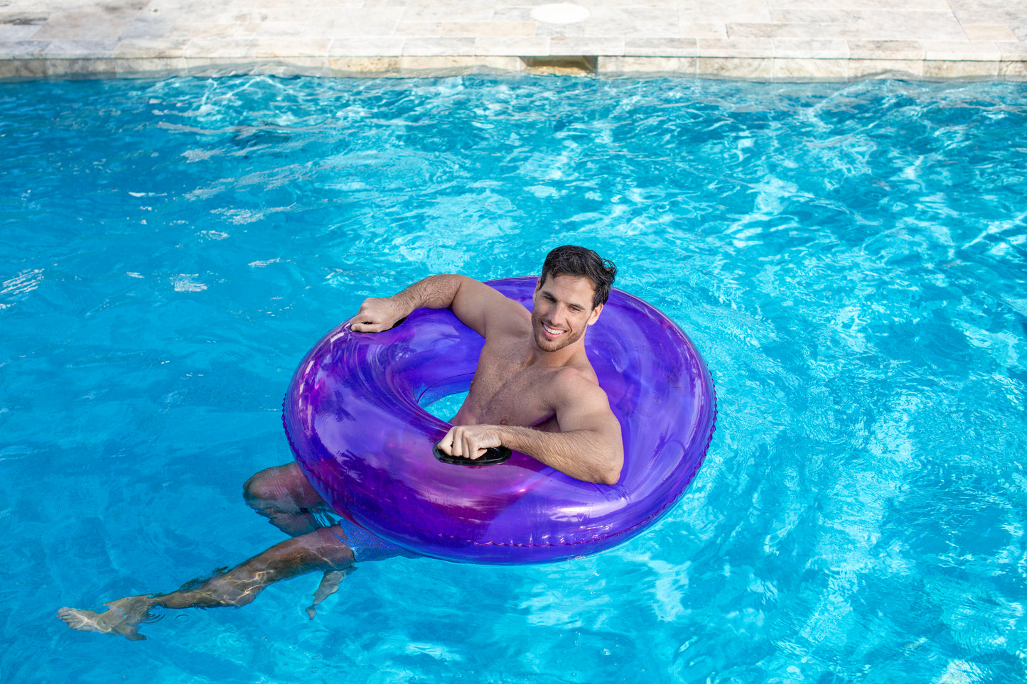 PoolCandy Translucent Purple Inflatable Swim Ring by PoolCandy with pro handles in 48" size. Pro level pool, beach and river float.